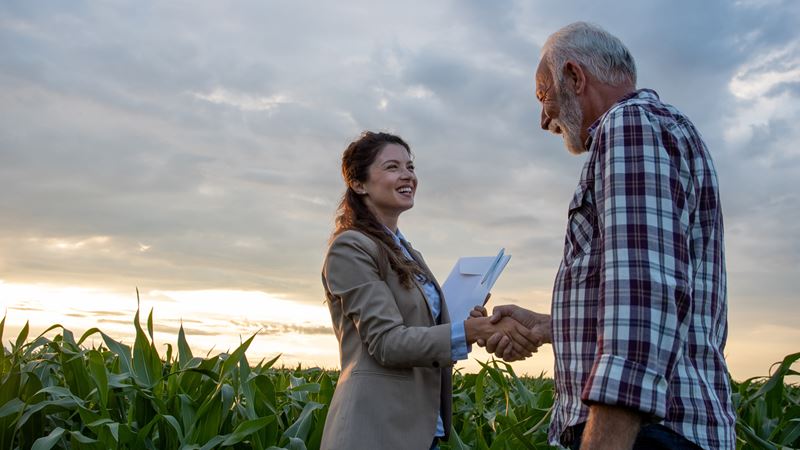 Woman shaking hands with Farmer