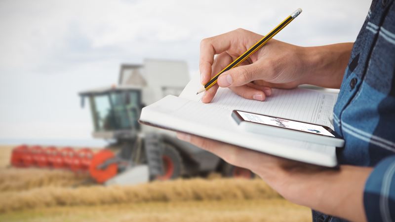 Farmer with notebook and phone