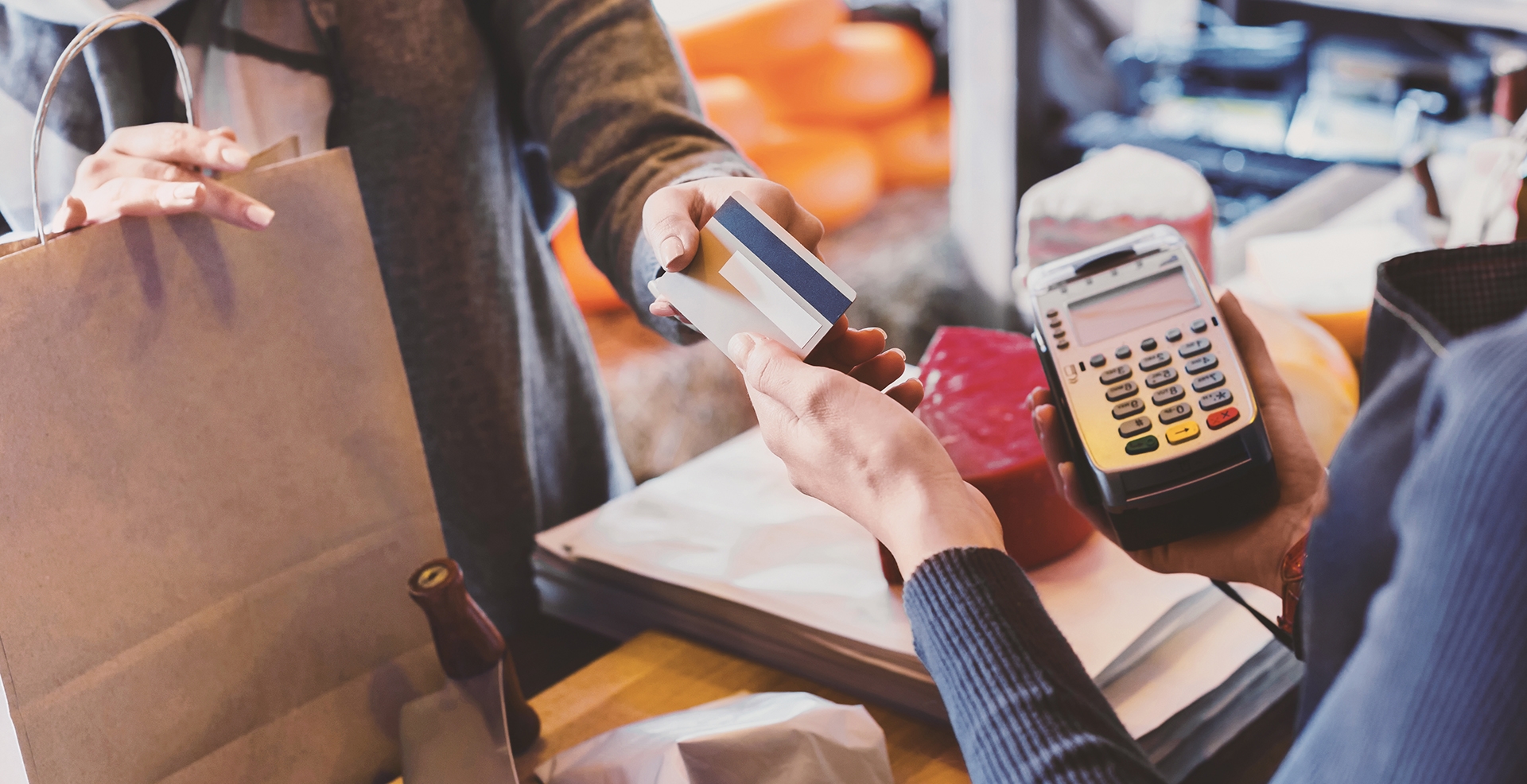 two people exchanging a credit card after a purchase